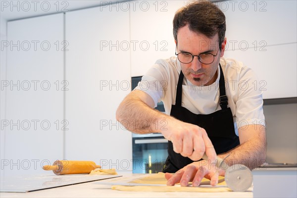 Man baking homemade croissants