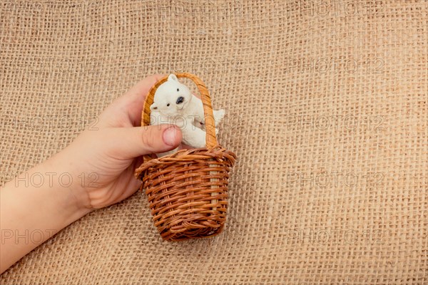 Hand holding a Polar bear model in hand on canvas