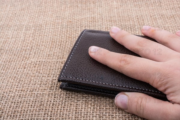 Brown leather wallet in hand saving and finance concept