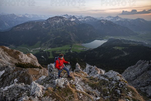 Hiker at the summit of Schartschrofen at sunset