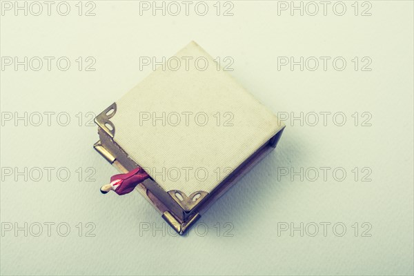 Tiny figurine of man models found beside a book