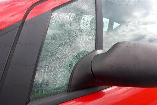 Broken front side car glass fractured into countless small pieces