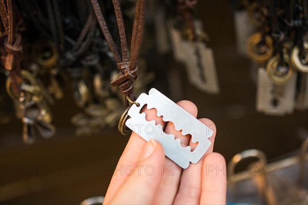 A steel razor blade necklace on sale in the view