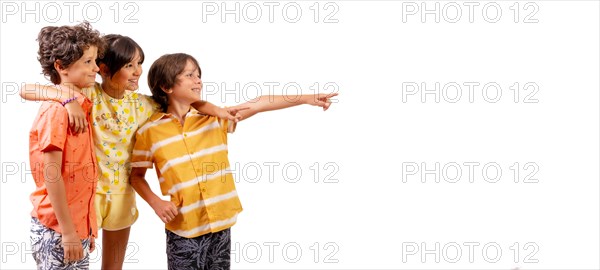 Caucasian kids hugging and pointing to the right