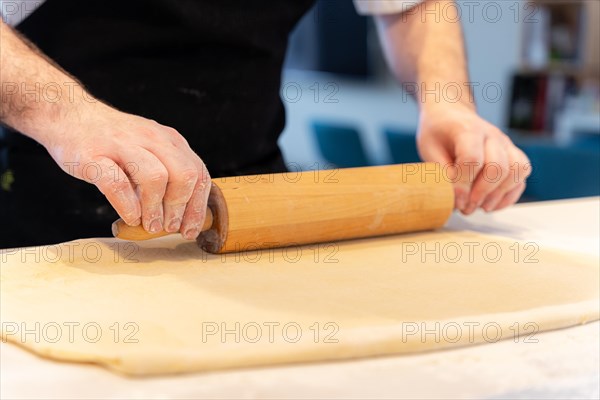 Confectioner man baking homemade croissant