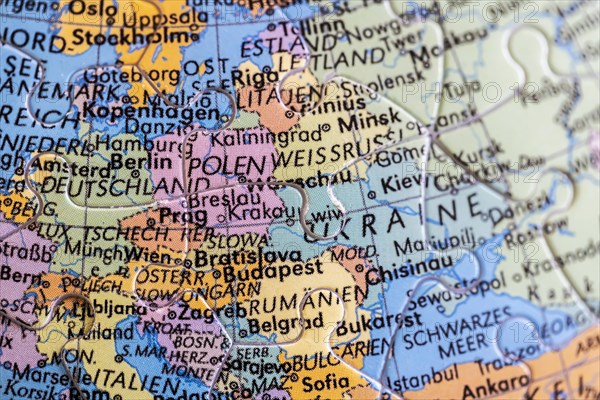 Globe made of puzzle pieces. Europe with Ukraine