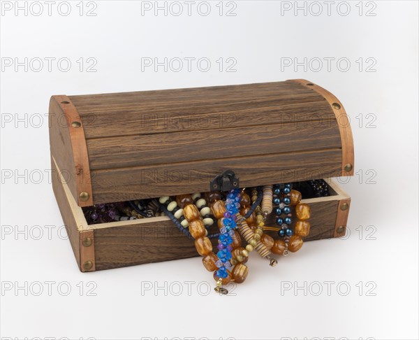 Half-opened wooden box with colourful pearl jewellery