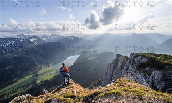 Hiker at the summit of Schartschrofen at sunset