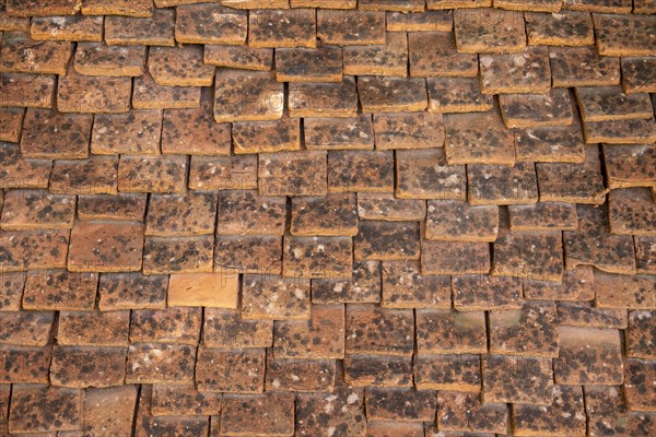 Tiled roof made of handmade tiles as texture or background