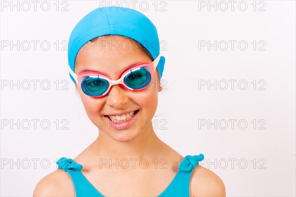Portrait of girl with swimsuit and diving goggles for swimming lessons in the pool in summer. White background