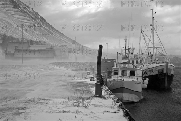 Fishermen lying at the harbour on a stormy day