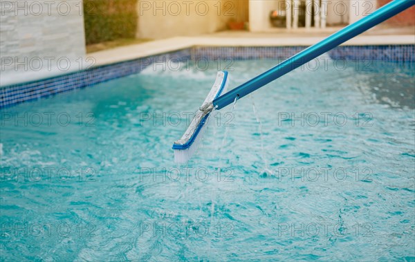 Swimming pool cleaning with brush. Pool brush for wall cleaning