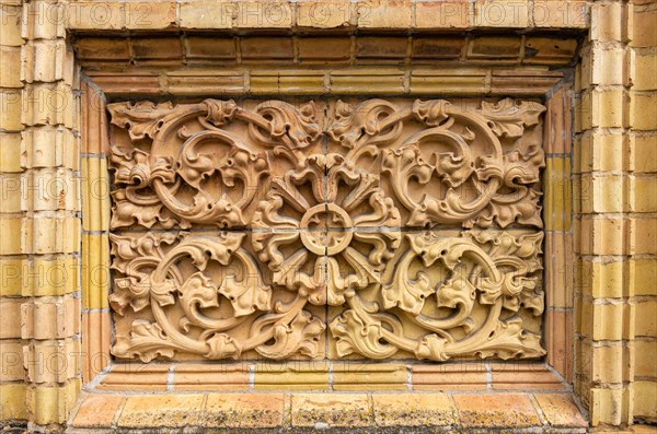 Historic architectural exterior detail with tendril ornamentation made of brick material