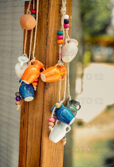 A bunch of colorful miniature clay pitcherse on display