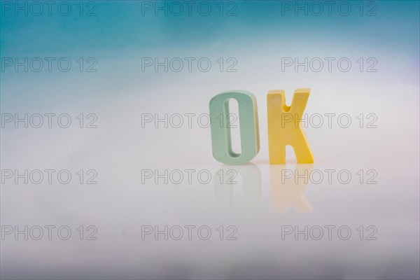 The word OK written with colorful letter blocks