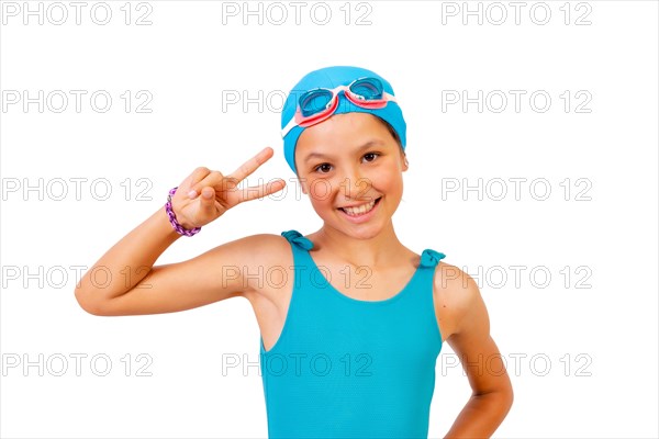 Portrait of girl with swimsuit and diving goggles for swimming lessons in the pool making the victory symbol. White background
