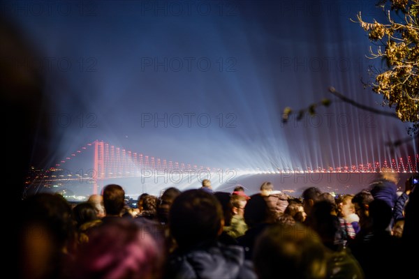 Crowd watch fireworks show over the Istanbul City View of Bosporus Bridge