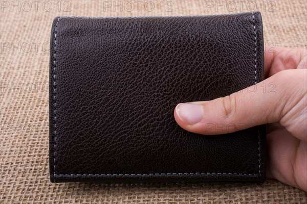 Brown leather wallet in hand saving and finance concept