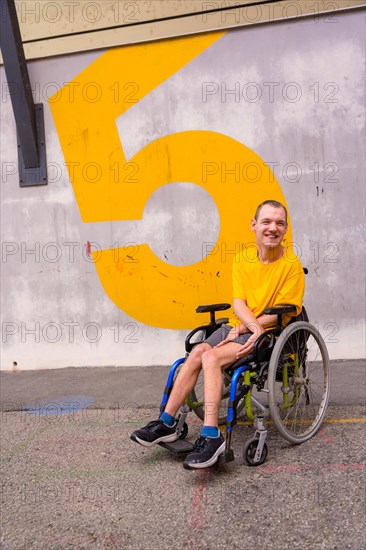 A disabled person in a public park in a wheelchair