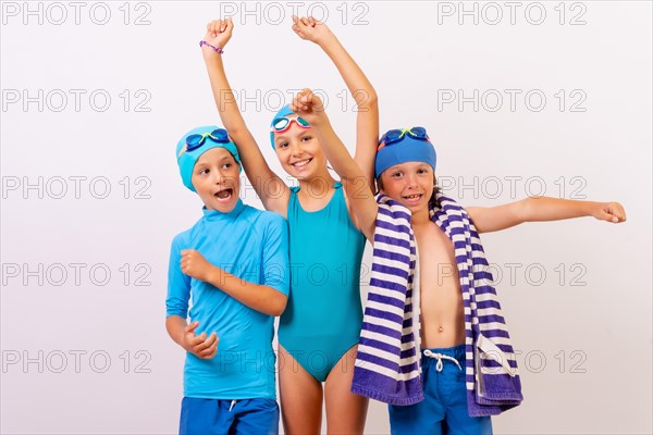 Portrait of brothers dressed in swimsuits for swimming lessons in the pool. White background