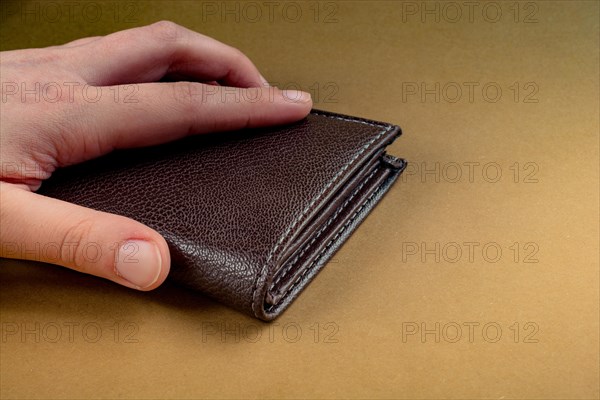 Brown leather wallet in hand saving and finance concept