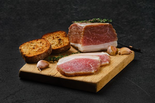 Salted pork belly joint meat with lard on wooden cutting board