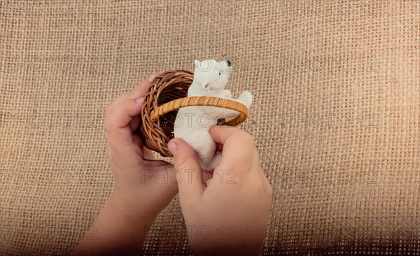 Hand holding a Polar bear model in hand on canvas