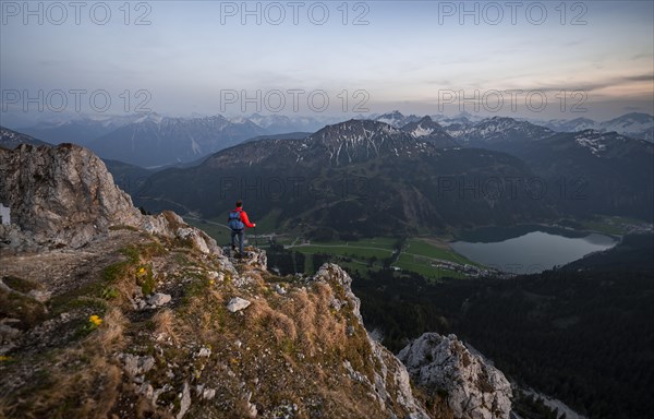 Hiker at the summit of Schartschrofen at sunset