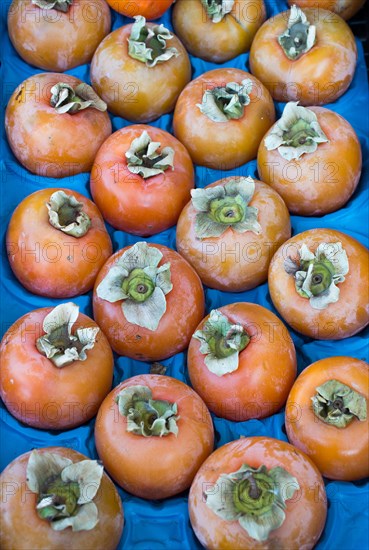 Persimmons in Turkish street bazaar in view