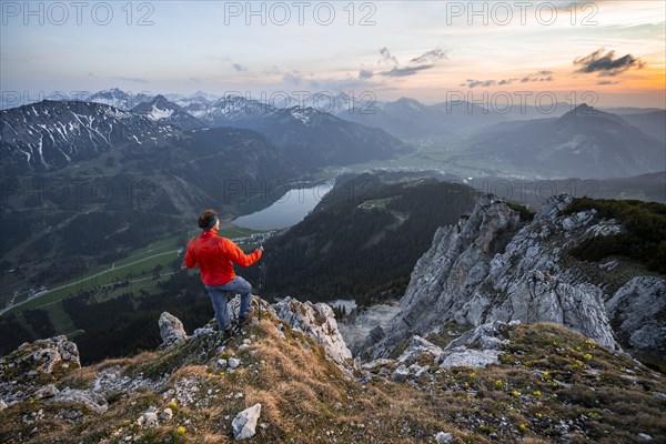 Hiker at the summit of Schartschrofen at sunset