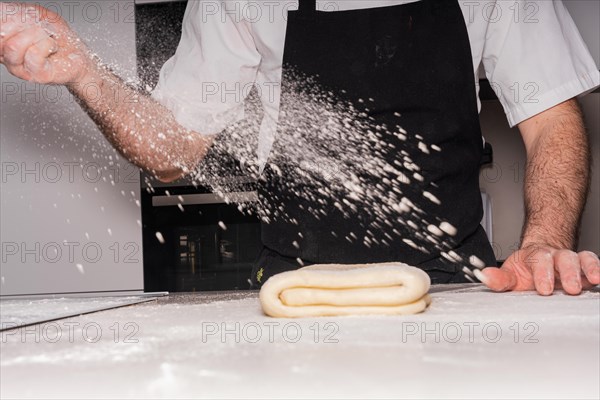 Confectioner man baking homemade croissants