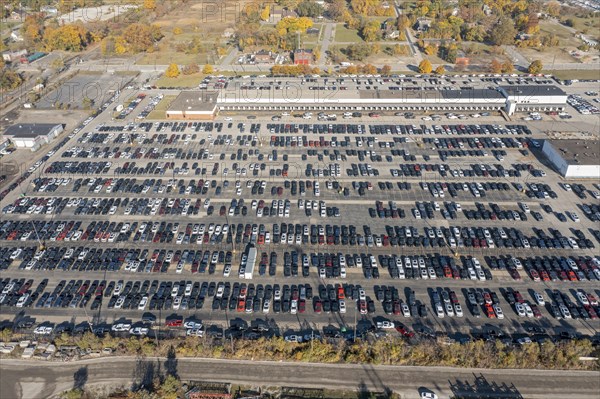 Ford pickup trucks are parked in a vacant warehouse parking lot