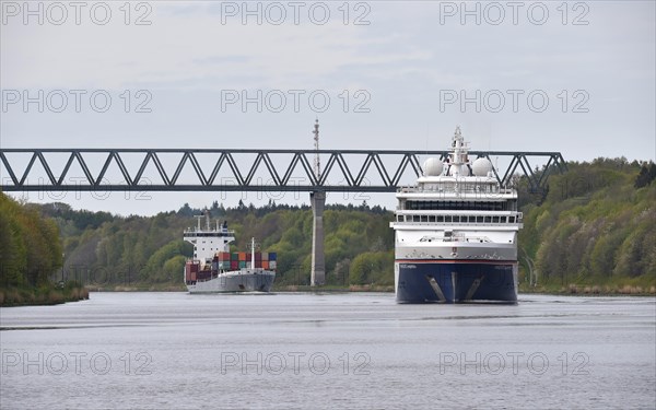 Cruise ship HANSEATIC inspiration and container ship sailing in the Kiel Canal at Gruenentaler Bruecke