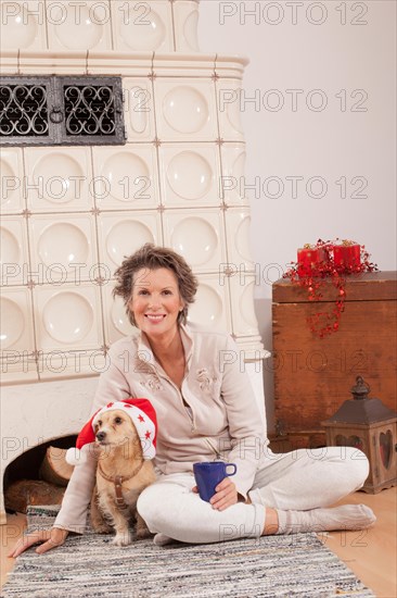 Woman with dog sitting on the ground