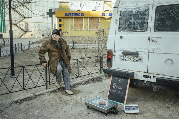 Potato vendor in front of his delivery van