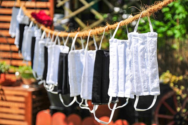 Self-sewn mouth-nose protection masks drying on a clothesline