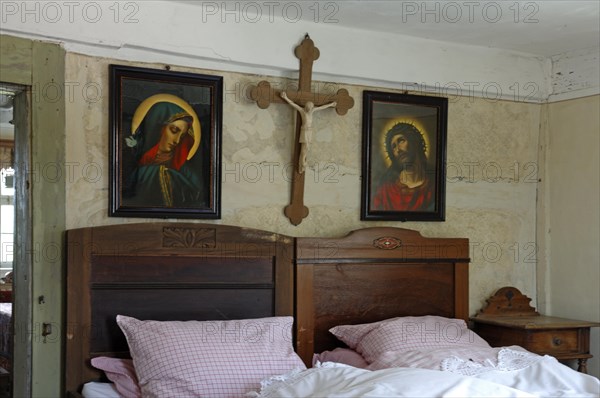Two pictures of saints above the marriage bed