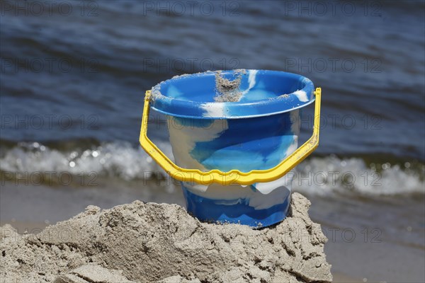 Toy and beach castle on a sandy beach by the sea