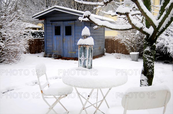 Garden table with chairs under a blanket of snow in winter