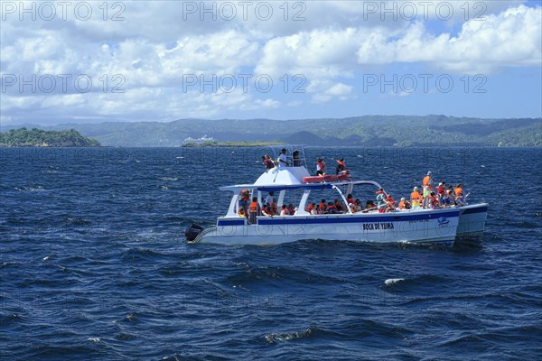 Tourists on a whale watching boat in Samana Bay