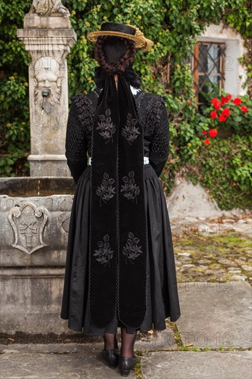 Rear view of a stylish woman in a shawl