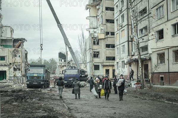 Residents of the house destroyed by a Russian missile attack that killed 45 people move their belongings from their homes