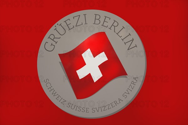 Red board with the Swiss flag and the inscription Grueezi Berlin