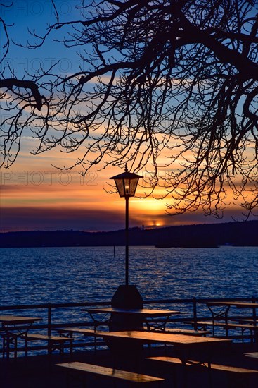 Winter sunset in a beer garden at Lake Ammer