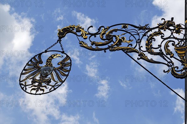 Nose sign with the city coat of arms at the Hotel Reichsstadt against cloudy sky