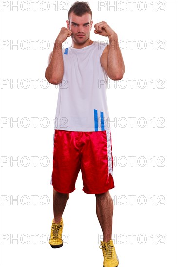 Bald fisted determined young male boxer falls into a defensive stance with his fists protecting his head as the place of challenge