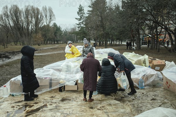 Residents of the house destroyed by a Russian missile attack that killed 45 people receive relief goods from neighbourhood donations