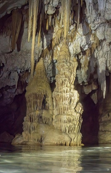 Limestone formations of karst rock above Stalagtites below Stalagmites grow together in dripstone cave