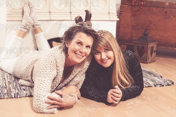 Mother and daughter lying on the ground