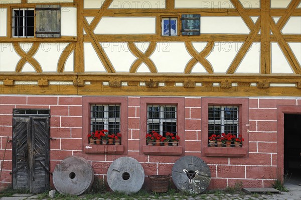 Three millstones in front of the mill